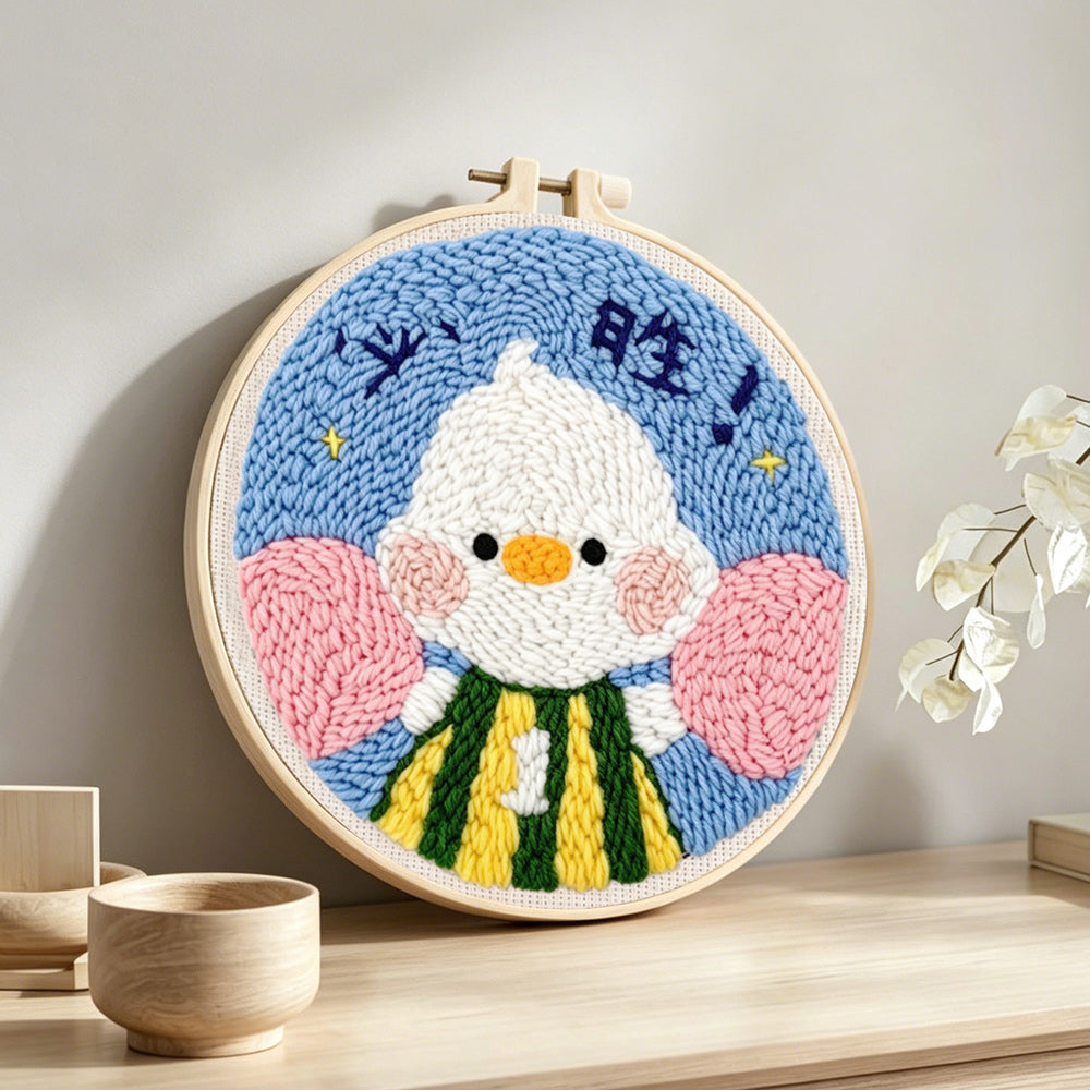 Motivated duck with fist pump punch needle artwork displayed on a table