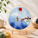 Finished mount fuji and cherry blossom needle felting displayed on a wooden easel