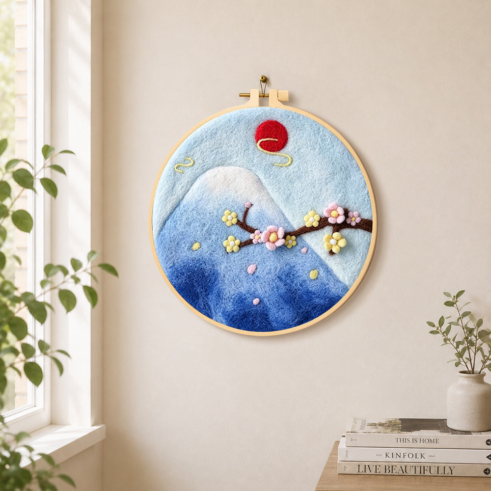 Mount fuji and cherry blossom needle felt wall art displayed in a bright home interior
