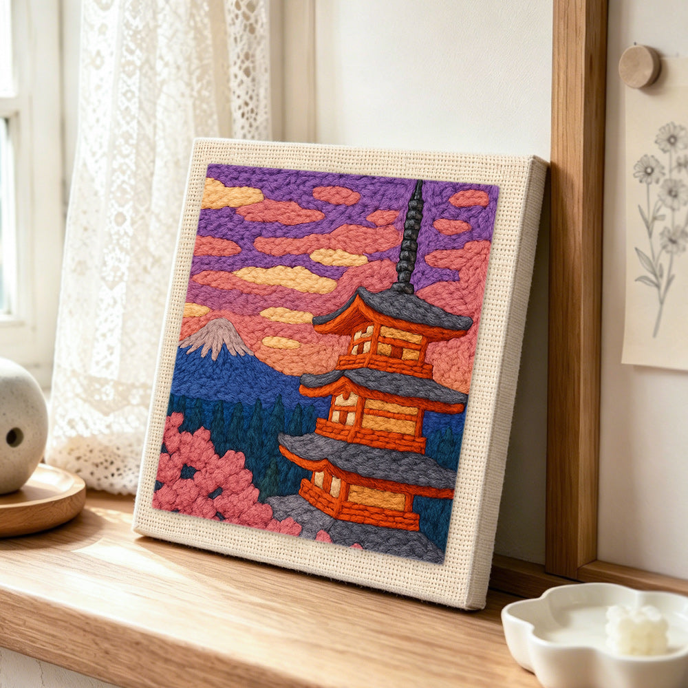 Mount fuji and pagoda punch needle artwork displayed on a table