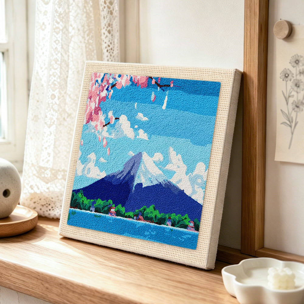 Mount fuji under the blue sky punch needle artwork displayed on a table