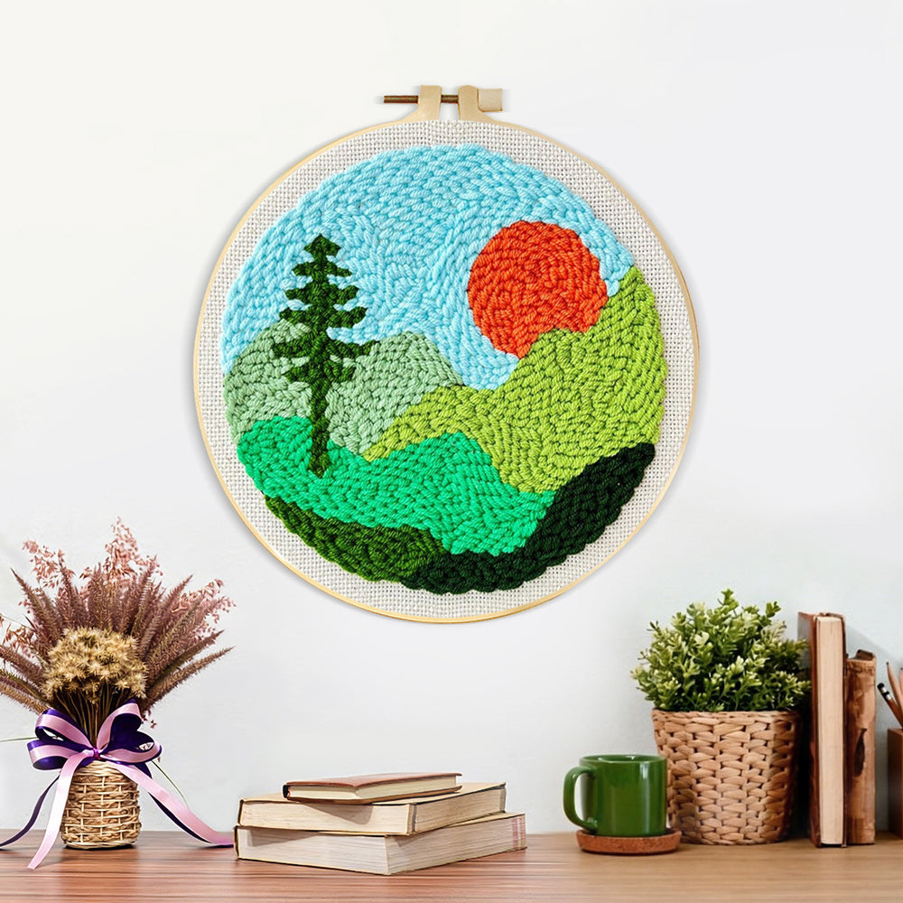 Finished mountain landscape with sun and tree artwork displayed on a wall