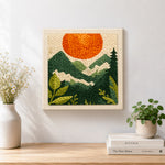 Finished mountain view and sunset artwork displayed on a wall