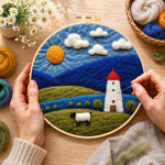 Creating the mountains and white tower at night wool painting by hand with a felting needle