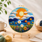 Finished mountains and wildflowers at sunset needle felting displayed on a wooden easel