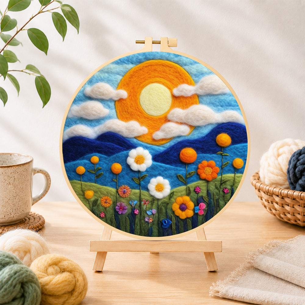Finished mountains and wildflowers at sunset needle felting displayed on a wooden easel
