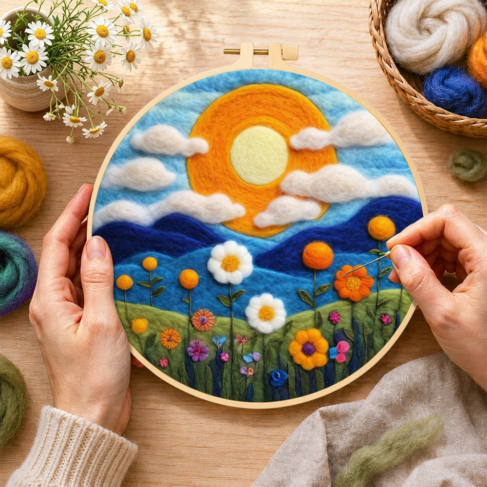 Creating the mountains and wildflowers at sunset wool painting by hand with a felting needle