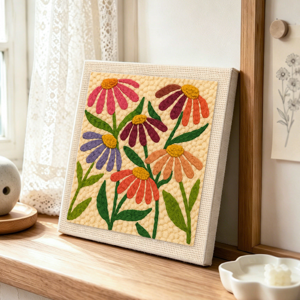Multicolour daisies punch needle artwork displayed on a table