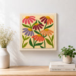 Finished multicolour daisies artwork displayed on a wall