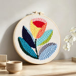 Multicoloured tulip punch needle artwork displayed on a table
