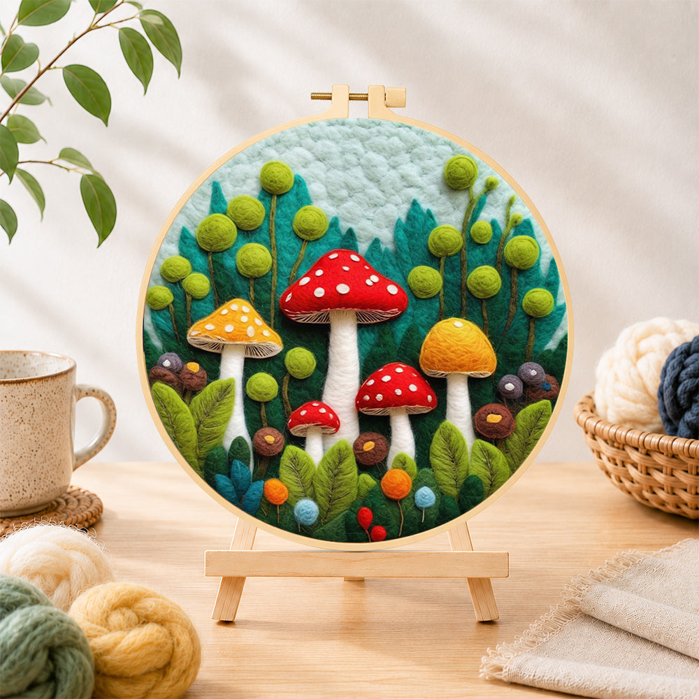 Finished mushroom group in forest wool needle felting displayed on a wooden easel