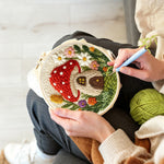 Creating handmade mushroom house punch needle artwork