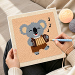 Creating handmade musical koala playing accordion punch needle artwork