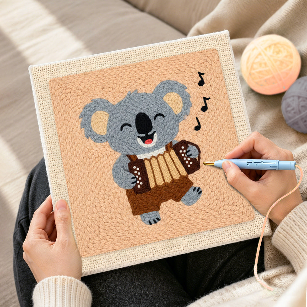 Creating handmade musical koala playing accordion punch needle artwork