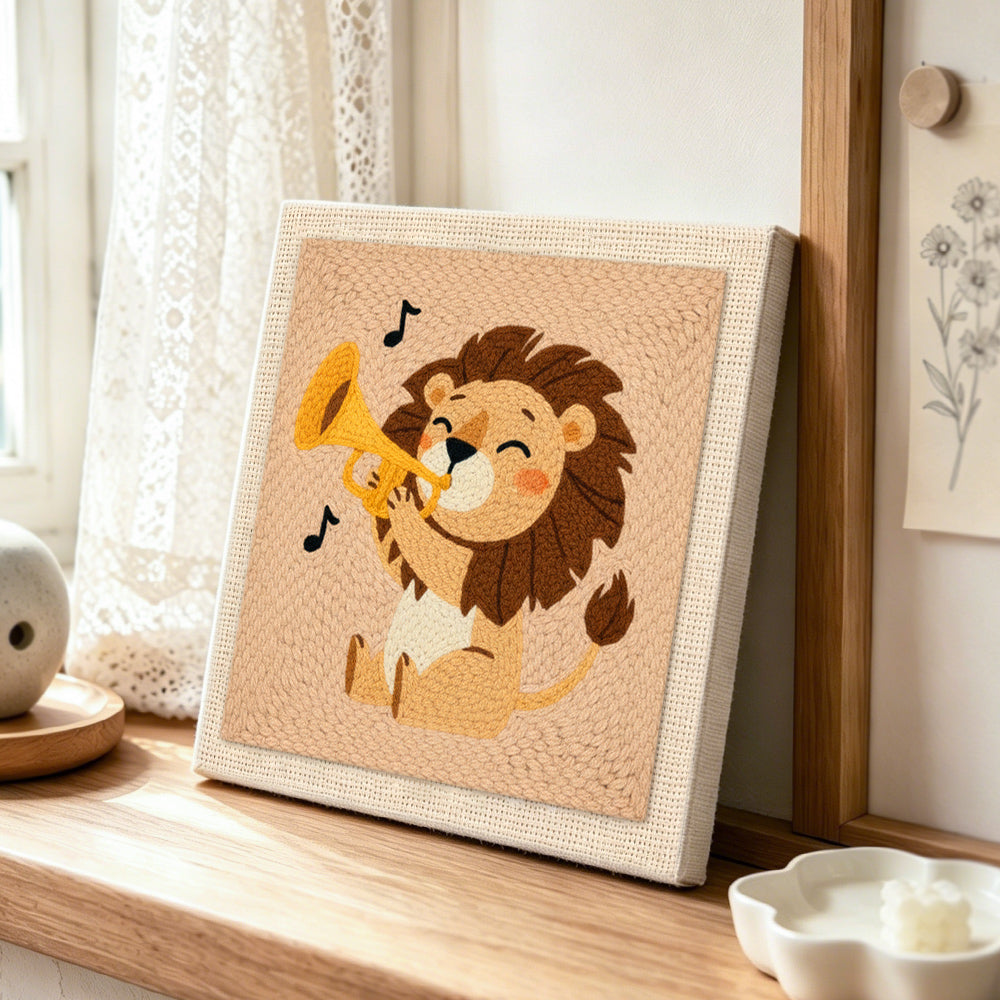 Musical lion playing the trumpet punch needle artwork displayed on a table