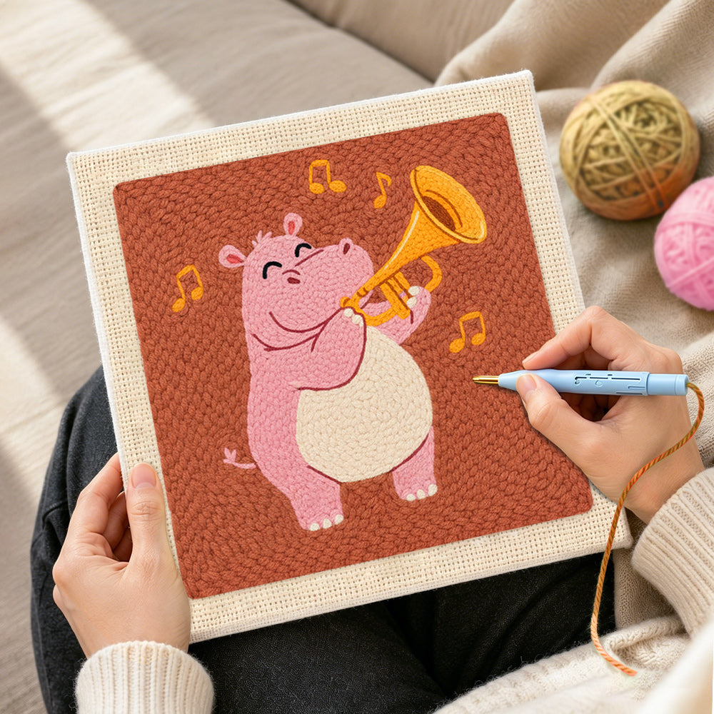 Creating handmade musical pink hippo with trumpet punch needle artwork