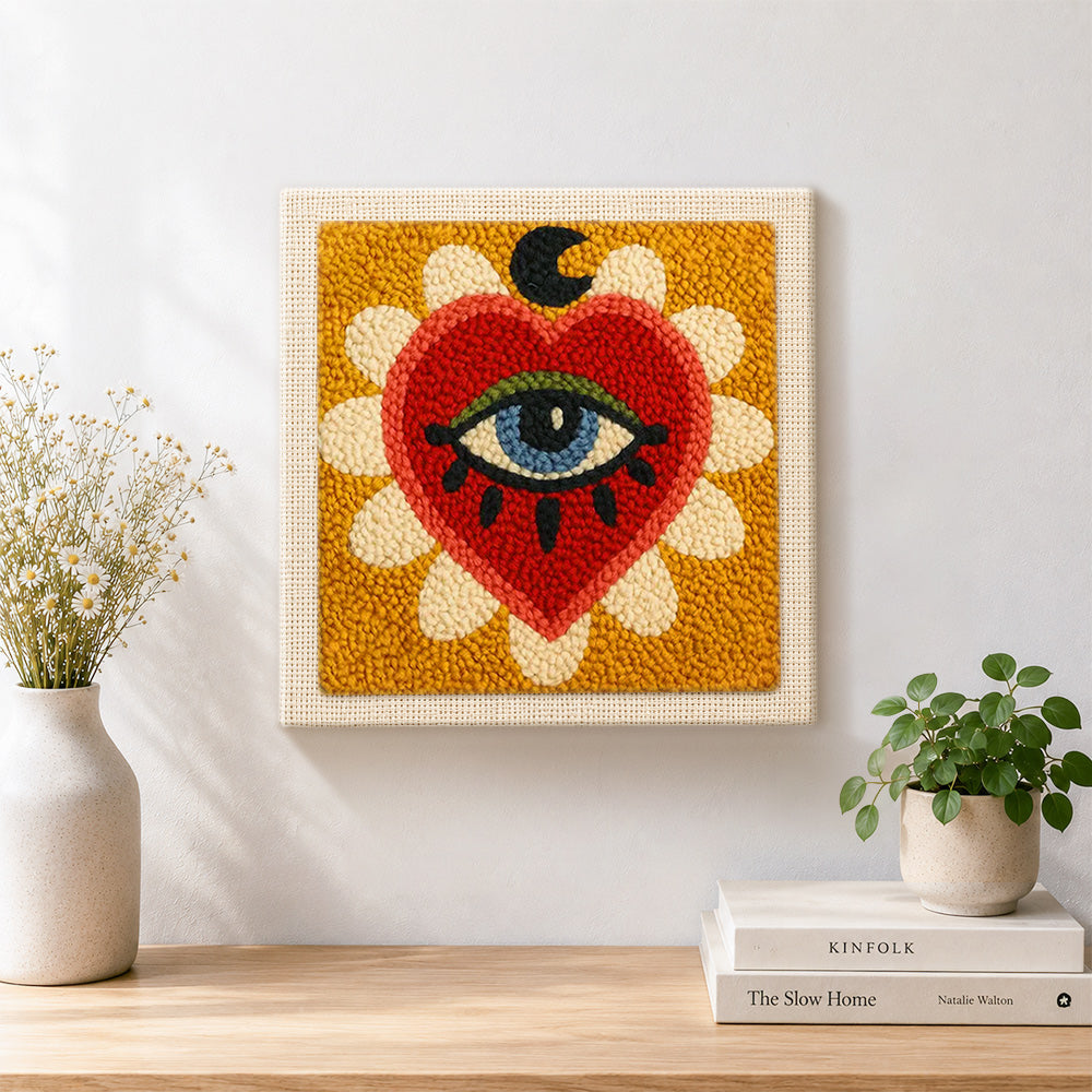 Finished mystical evil eye heart artwork displayed on a wall