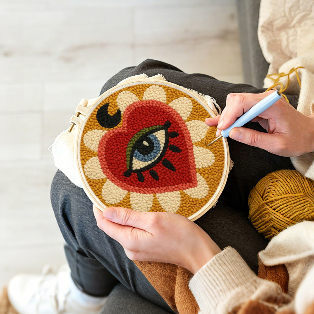 Creating handmade mystical heart and evil eye sunburst punch needle artwork