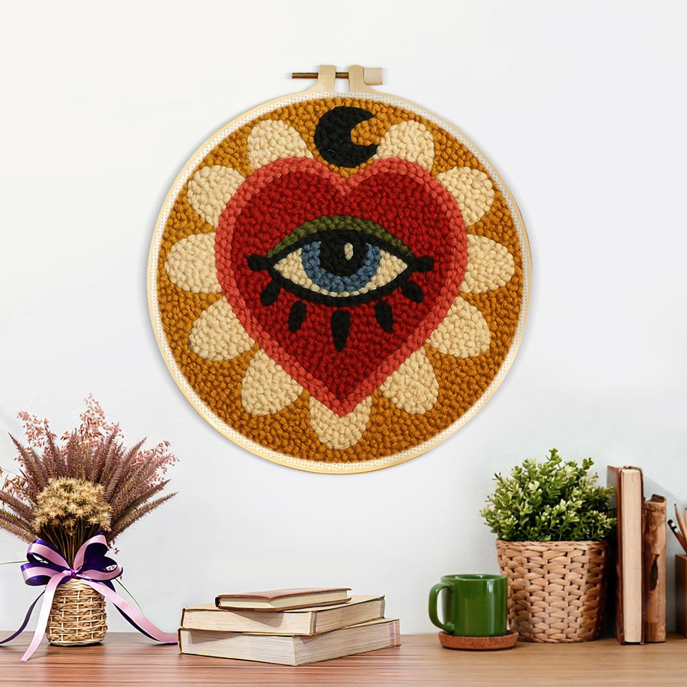 Finished mystical heart and evil eye sunburst artwork displayed on a wall