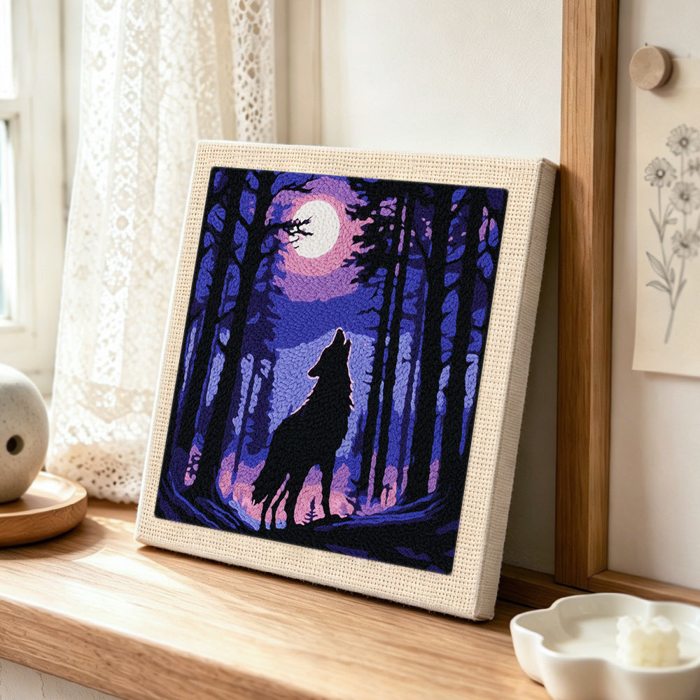 Mystical wolf howling at the moon punch needle artwork displayed on a table