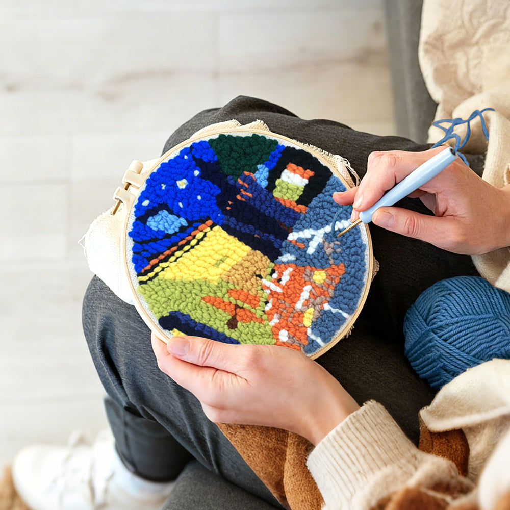 Creating handmade night scene with yellow-lit buildings punch needle artwork