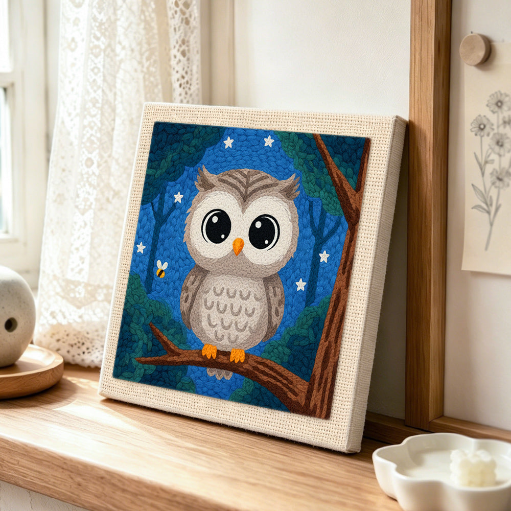 Night sky forest owl punch needle artwork displayed on a table