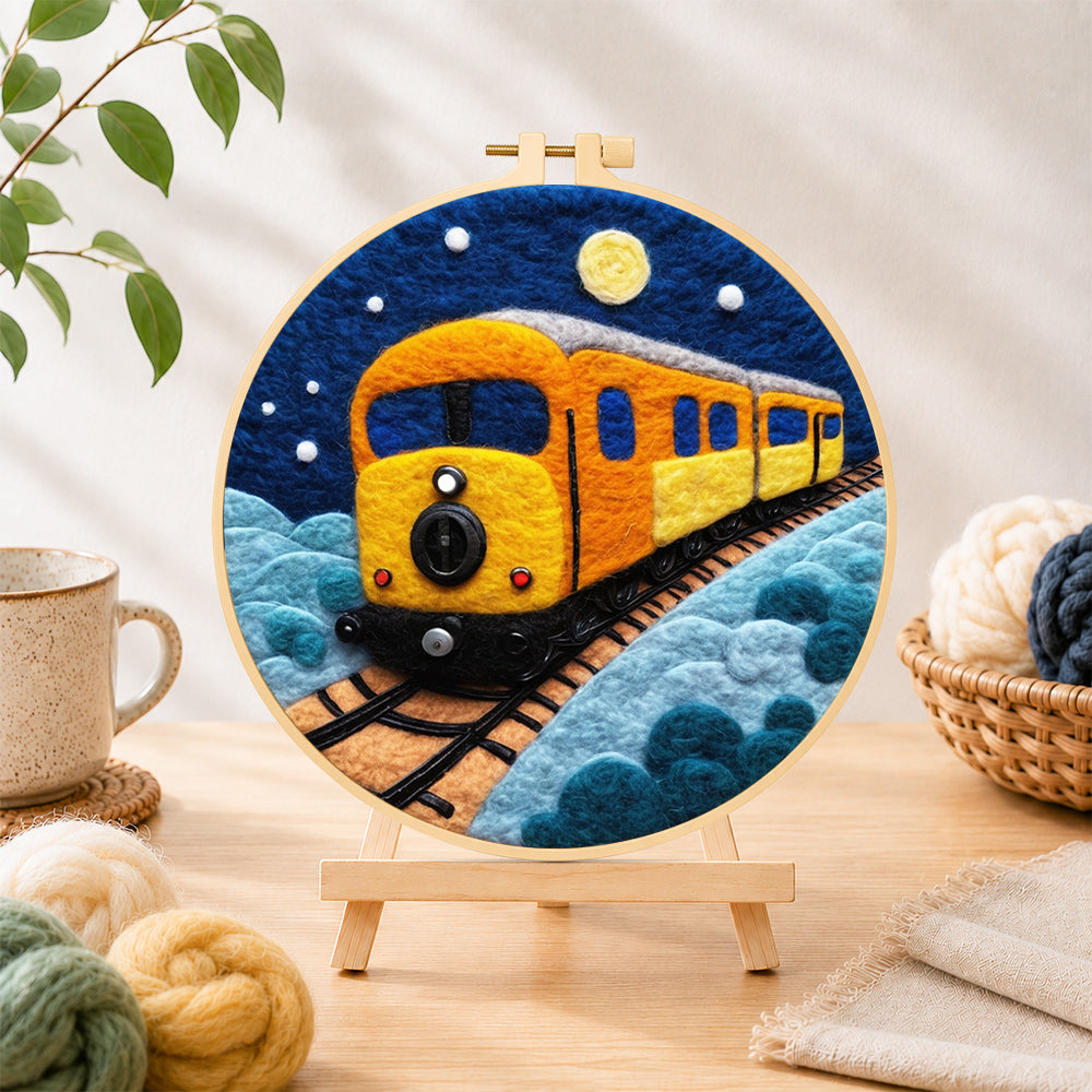 Finished night sky train needle felting displayed on a wooden easel
