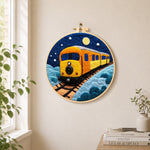 Night sky train needle felt wall art displayed in a bright home interior