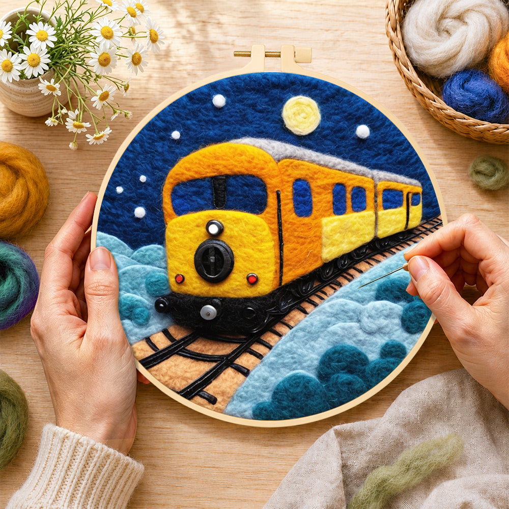 Creating the night sky train wool painting by hand with a felting needle
