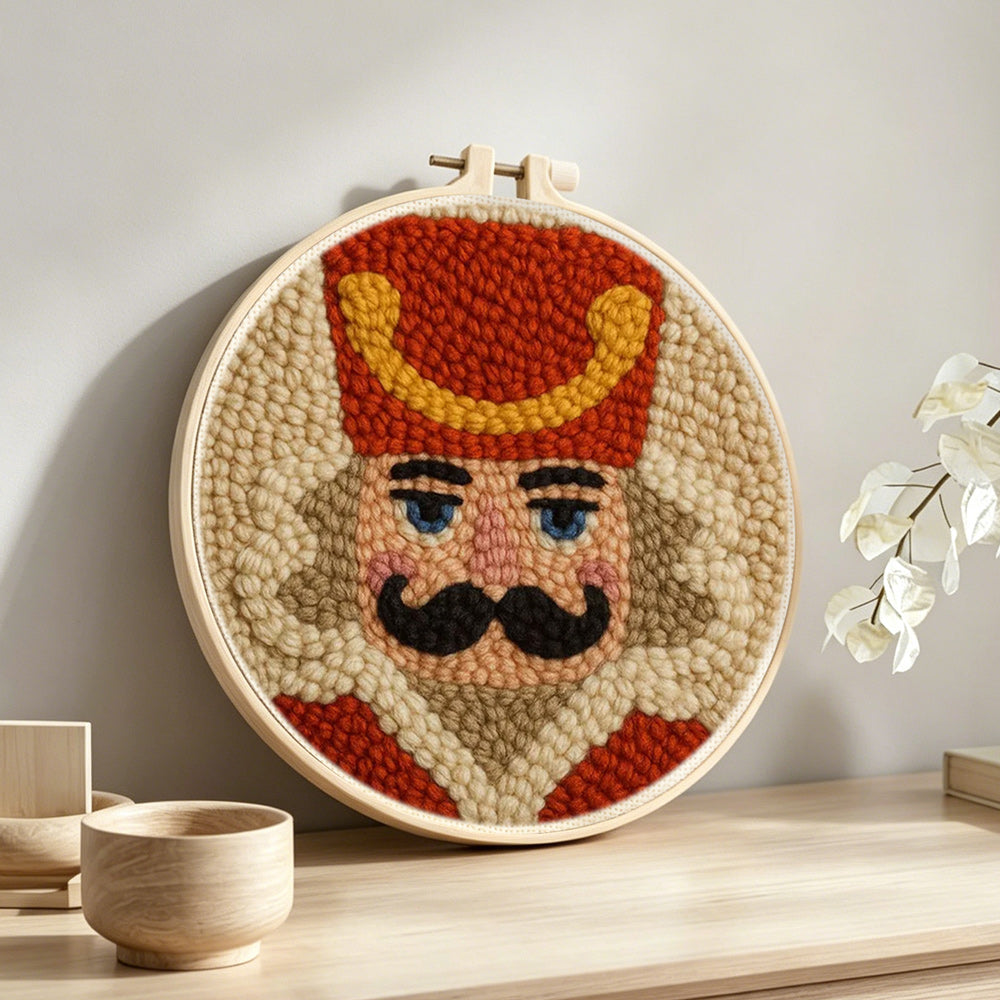 Nutcracker soldier portrait punch needle artwork displayed on a table
