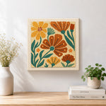 Finished orange and brown florals artwork displayed on a wall