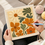 Creating handmade orange and cream flowers punch needle artwork