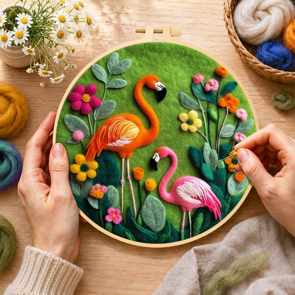 Creating the orange and pink flamingos among flowers wool painting by hand with a felting needle