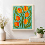 Finished orange and yellow tulip flowers artwork displayed on a wall