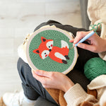 Creating handmade orange baby fox punch needle artwork