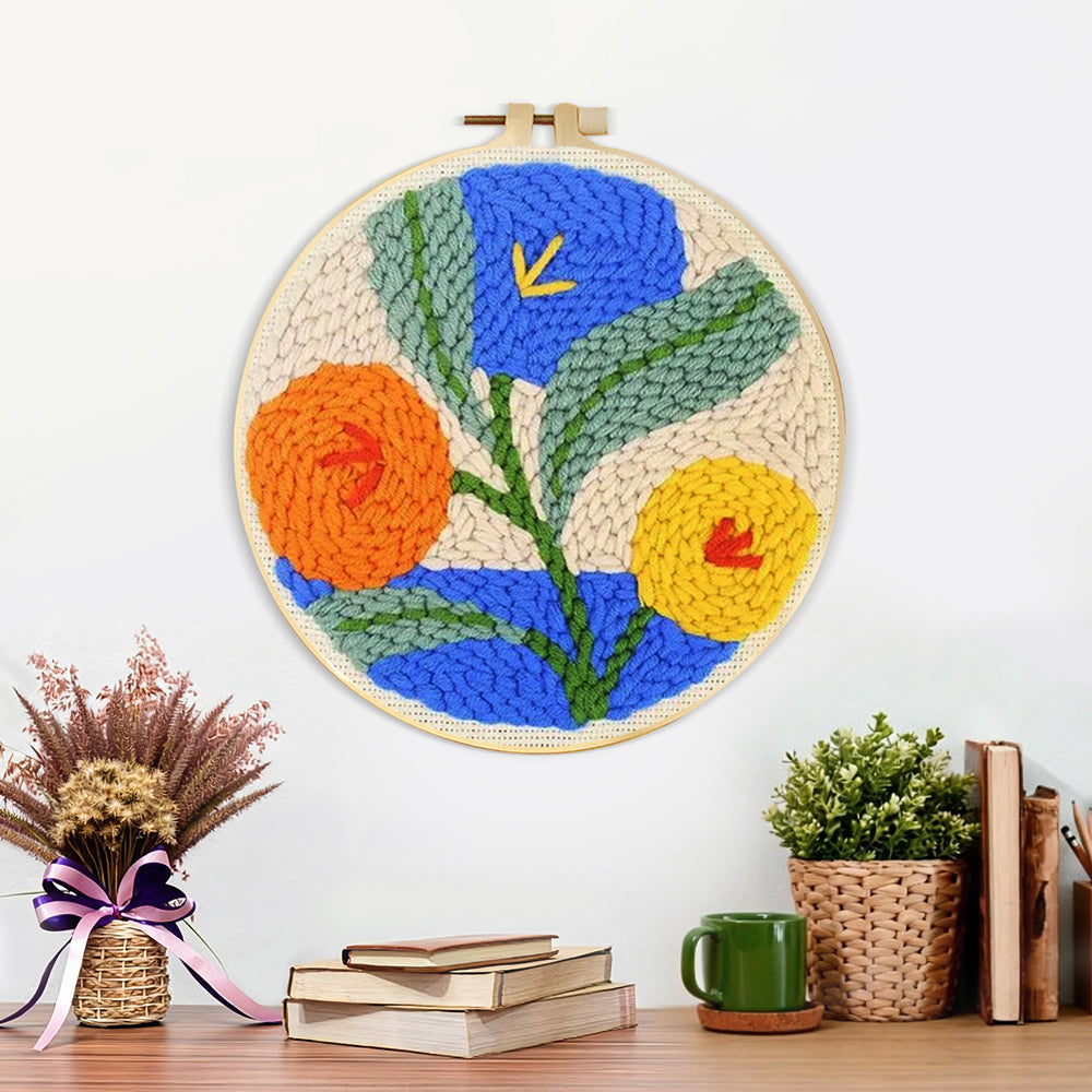 Finished orange, blue and yellow blooms artwork displayed on a wall