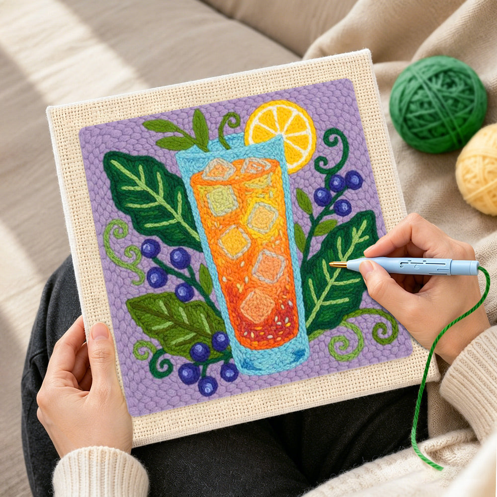 Creating handmade orange cocktail, blueberries and botanical leaves punch needle artwork