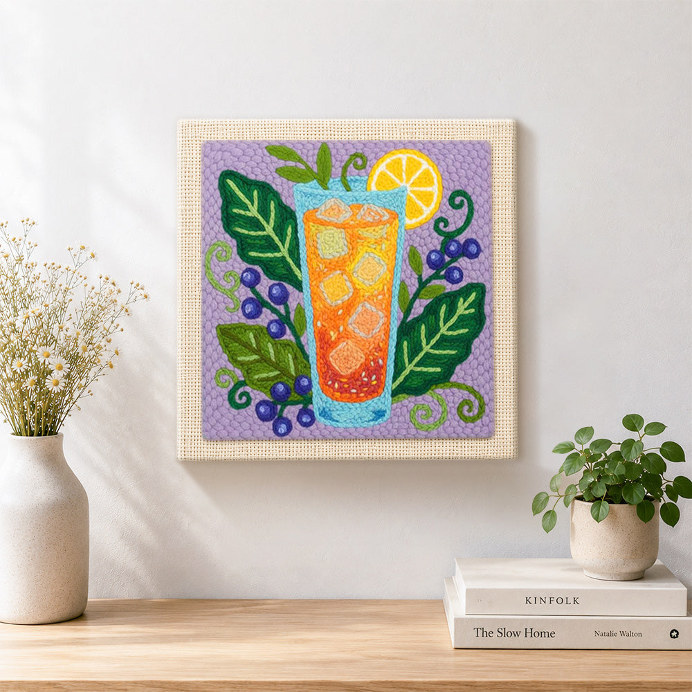 Finished orange cocktail, blueberries and botanical leaves artwork displayed on a wall