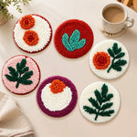 Orange flowers and green leaves punch needle coasters used for home decoration