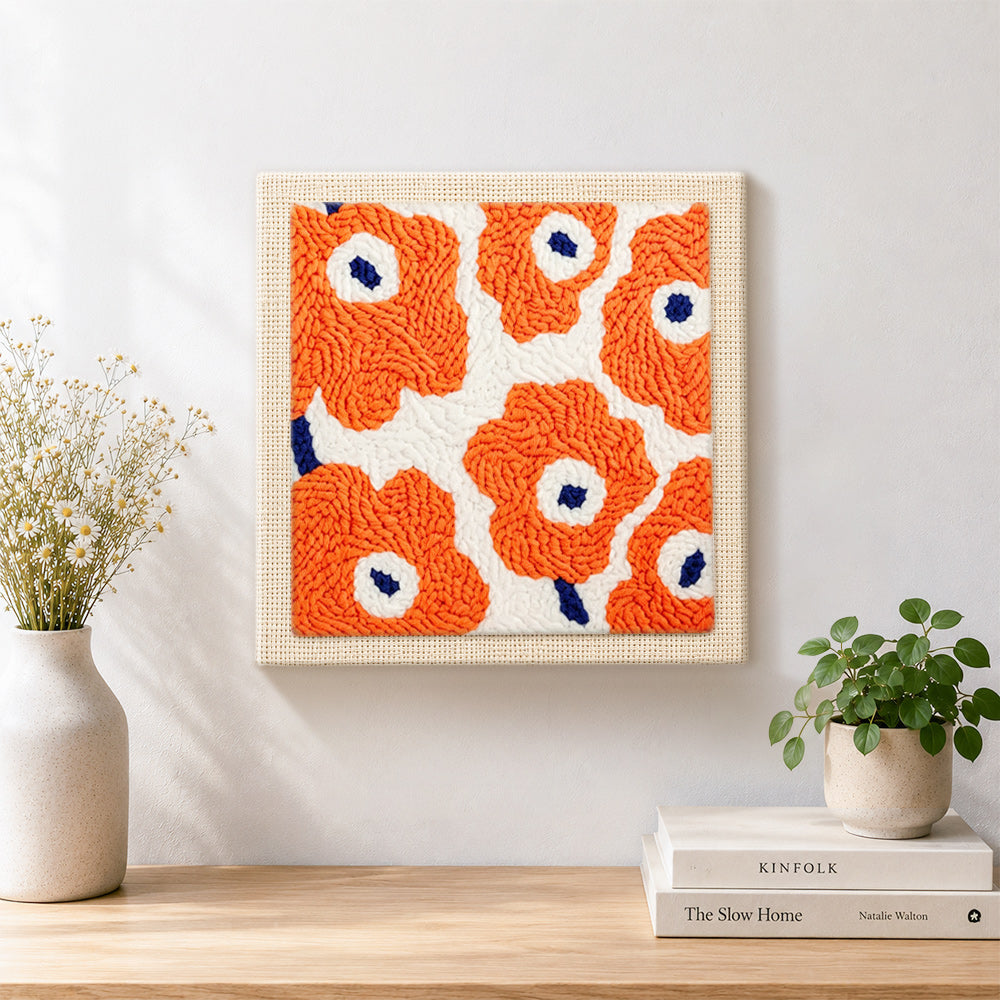 Finished orange flowers artwork displayed on a wall