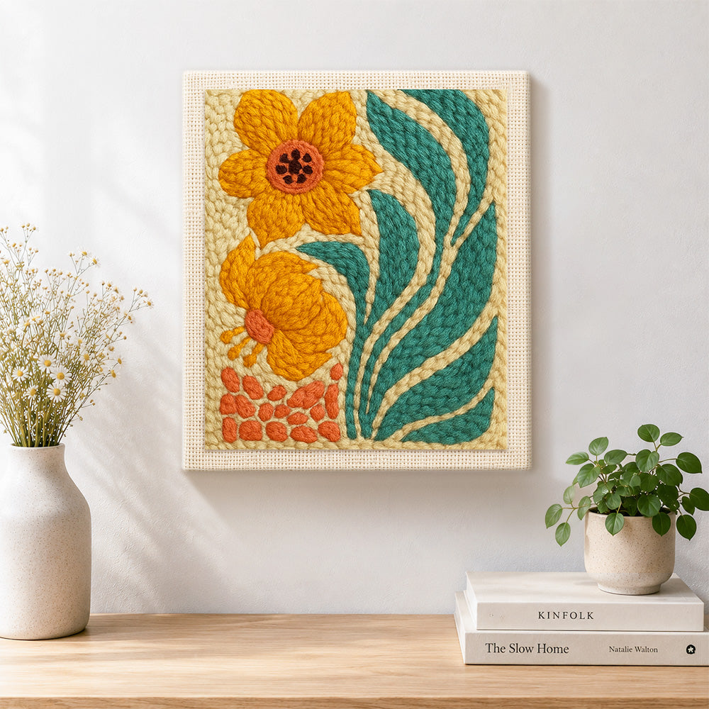 Finished orange flowers with giant leaves artwork displayed on a wall