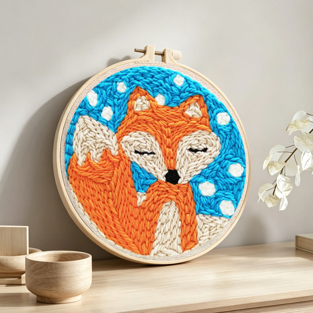 Orange fox punch needle artwork displayed on a table