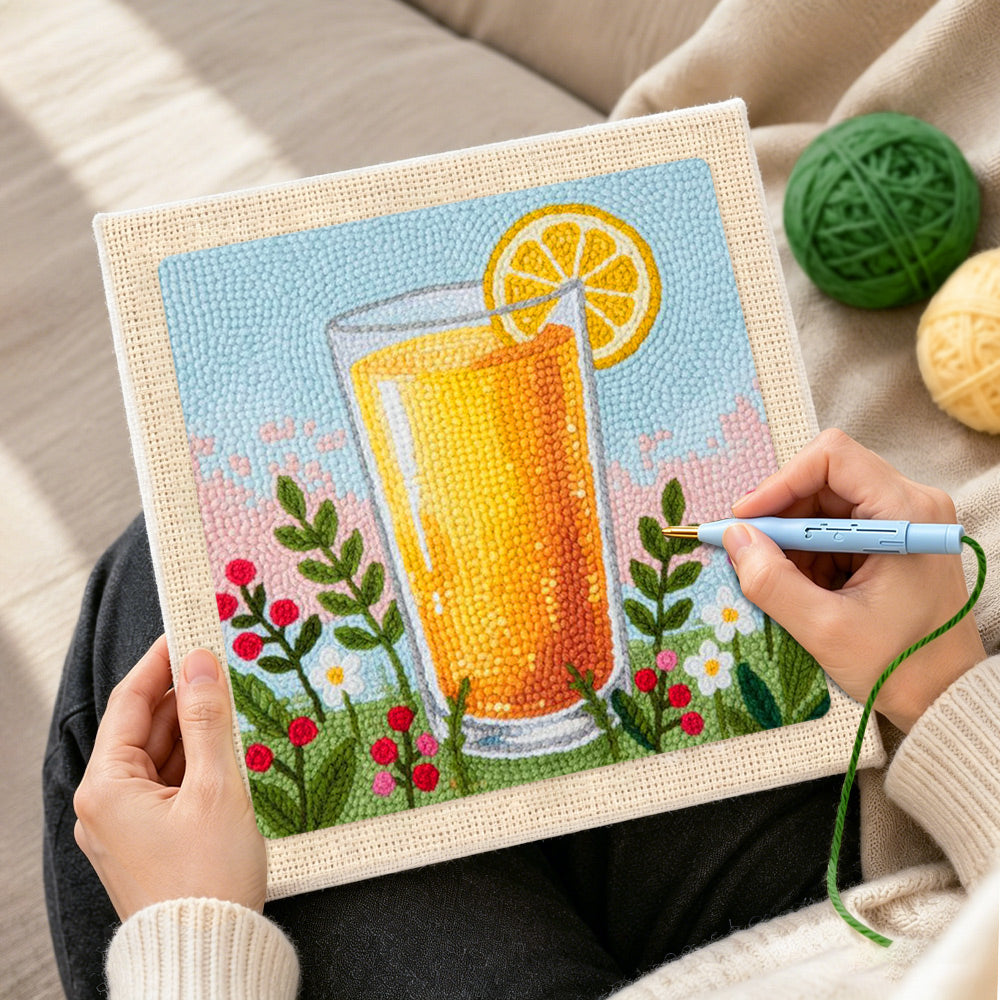 Creating handmade orange juice and some wildflowers punch needle artwork