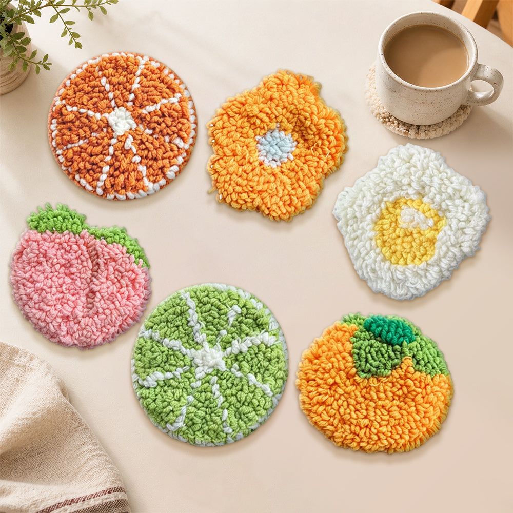 Orange, peach and fried egg punch needle coasters used for home decoration