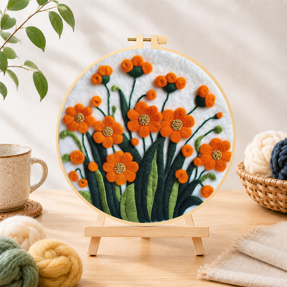 Finished orange-red flower cluster needle felting displayed on a wooden easel