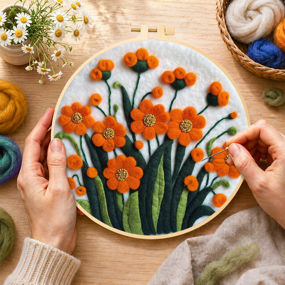Creating the orange-red flower cluster wool painting by hand with a felting needle