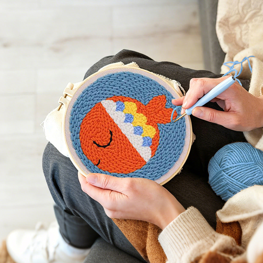 Creating handmade orange sea fish punch needle artwork
