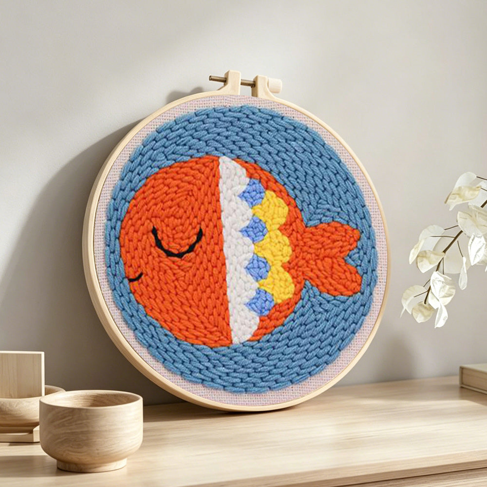 Orange sea fish punch needle artwork displayed on a table