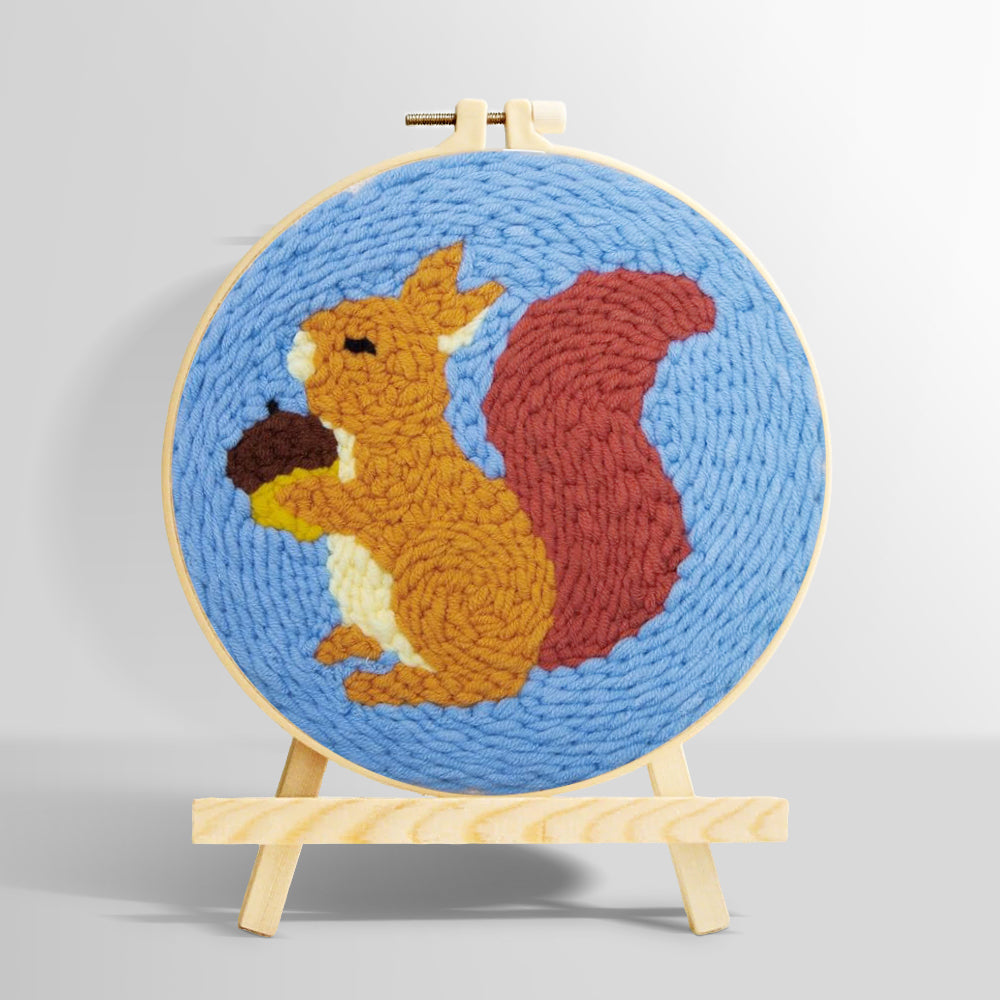 Orange squirrel holding pine cone punch needle kit for beginners