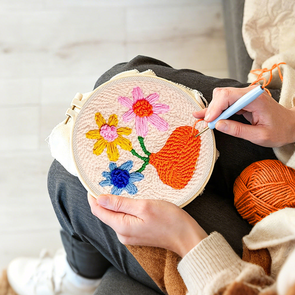 Creating handmade orange vase with colourful flowers punch needle artwork